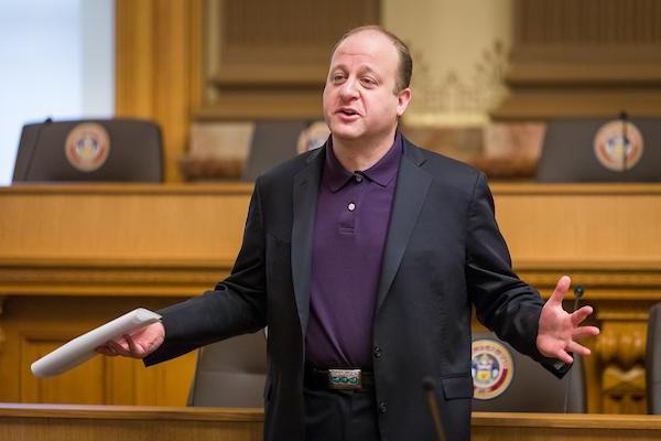 Colorado Governor Polis presenting to the audience. 